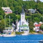 white and brown concrete building near body of water during daytime