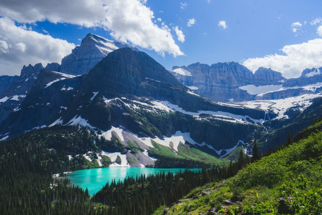 a view of a mountain range with a lake in the foreground